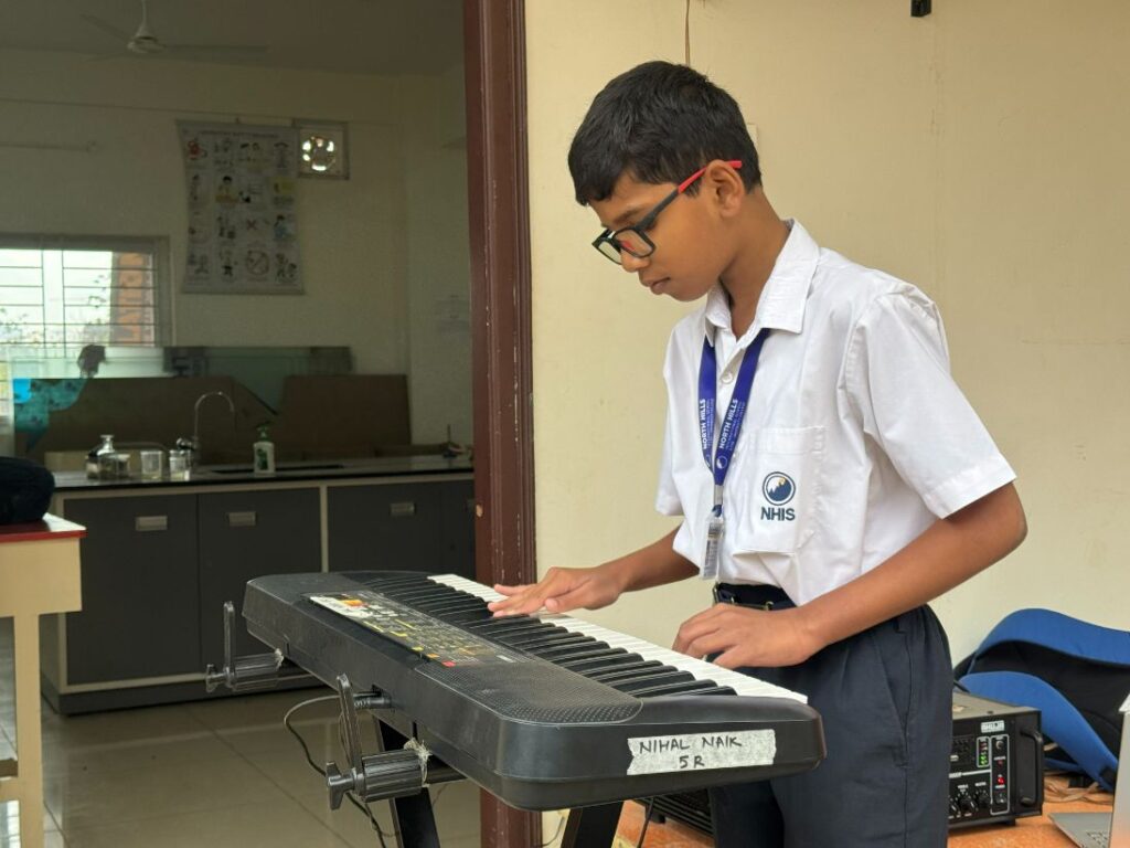 Student playing music keyboard