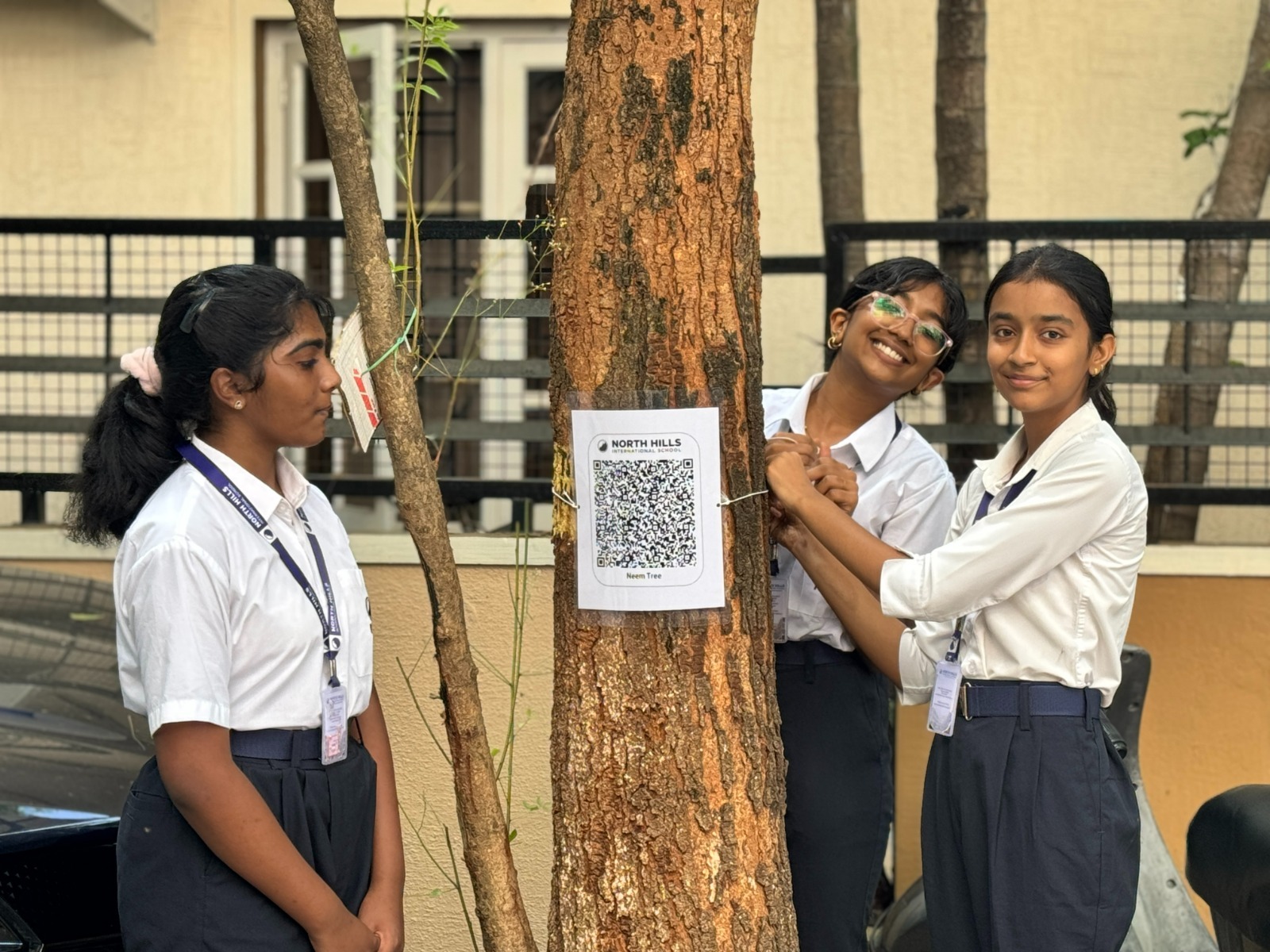 Students scanning tree QR code