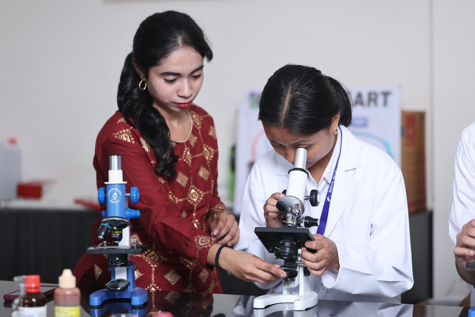 Teacher assisting biology lab experiment